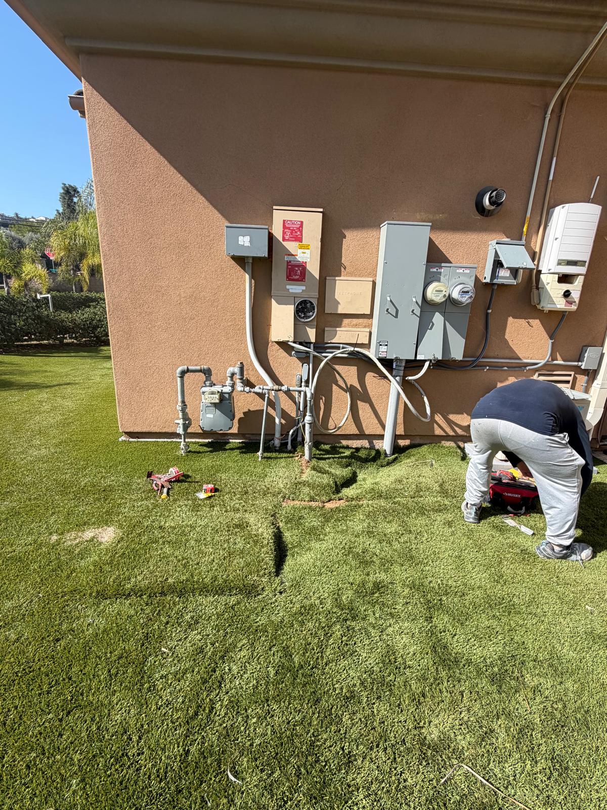 Electrician completing an indoor lighting installation in a San Diego home