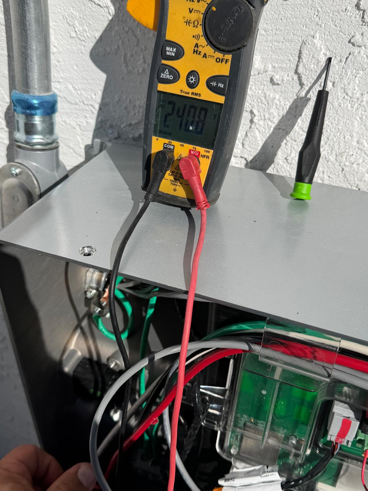Electrician voltage testing during electrical troubleshooting in San Diego