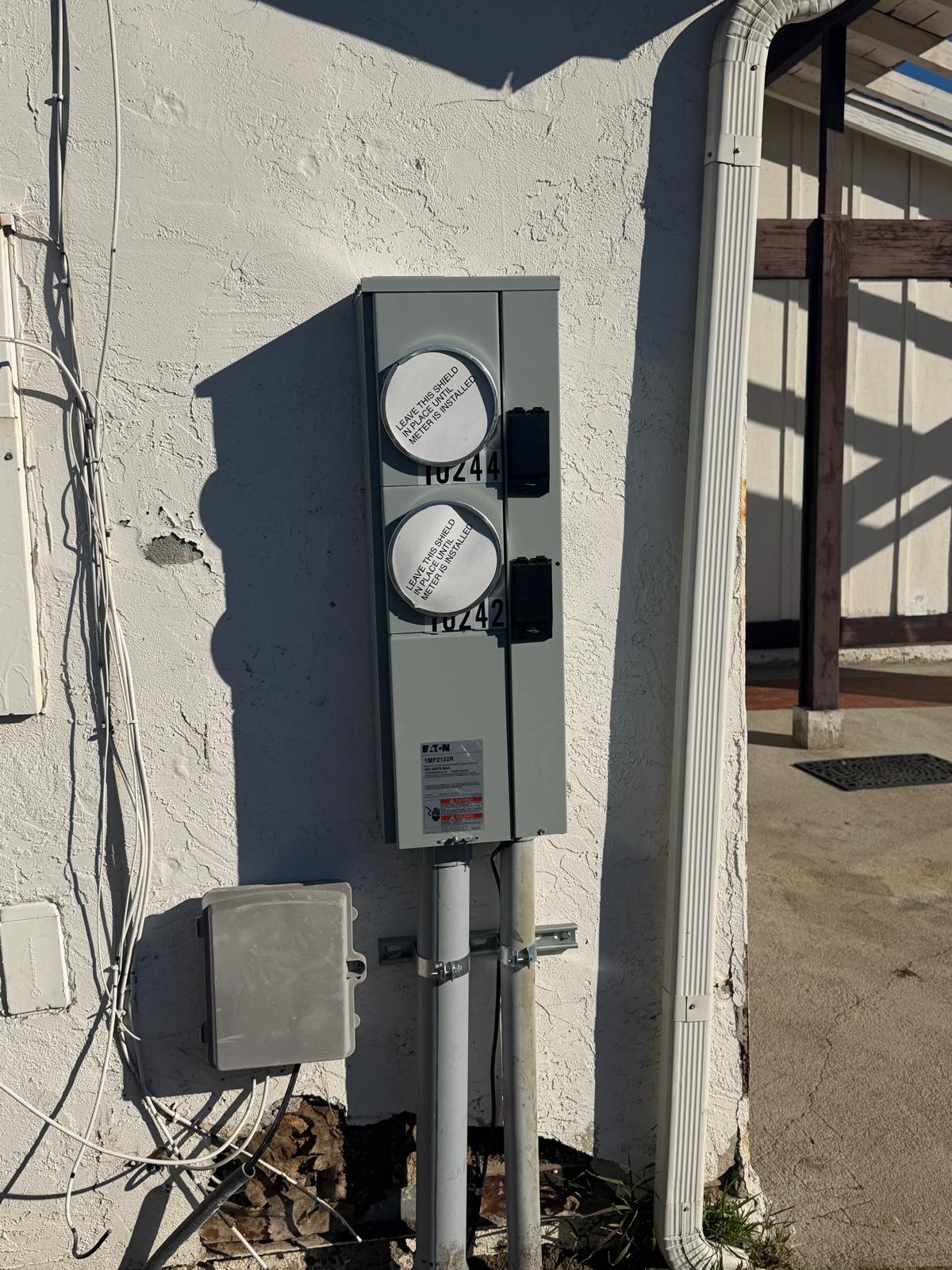 Exterior panel and transformer powering a landscape lighting system in San Diego