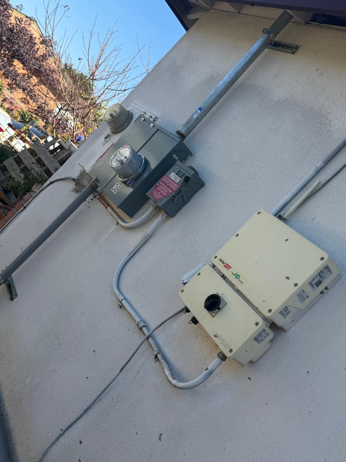 Exterior subpanel and conduit supplying a low-voltage landscape lighting transformer in San Diego