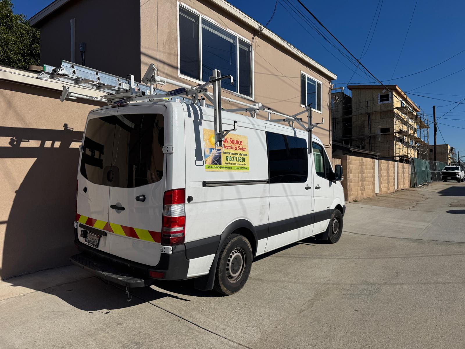 Sky Source Electric technician arriving in a service van in San Diego
