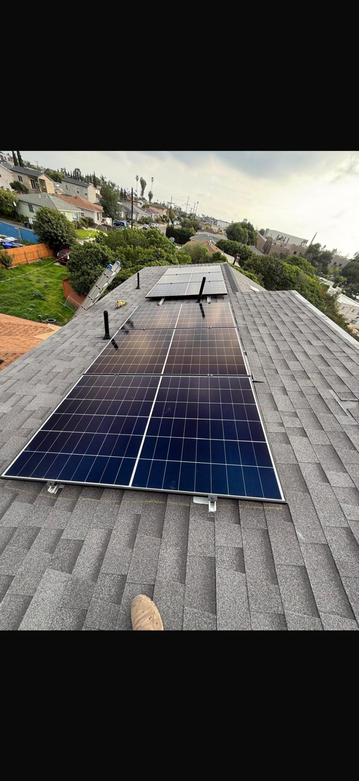 Solar panels mounted on a shingle roof of a San Diego home